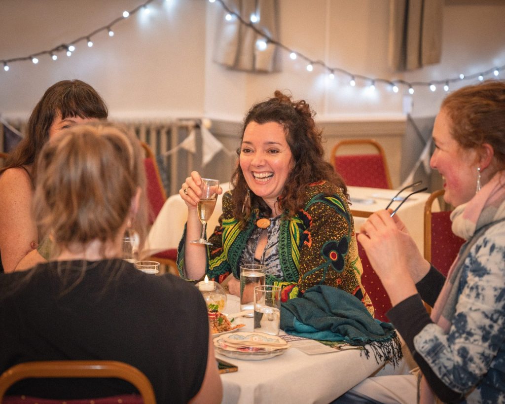 Ladies enjoying themselves dining and chatting and smiling