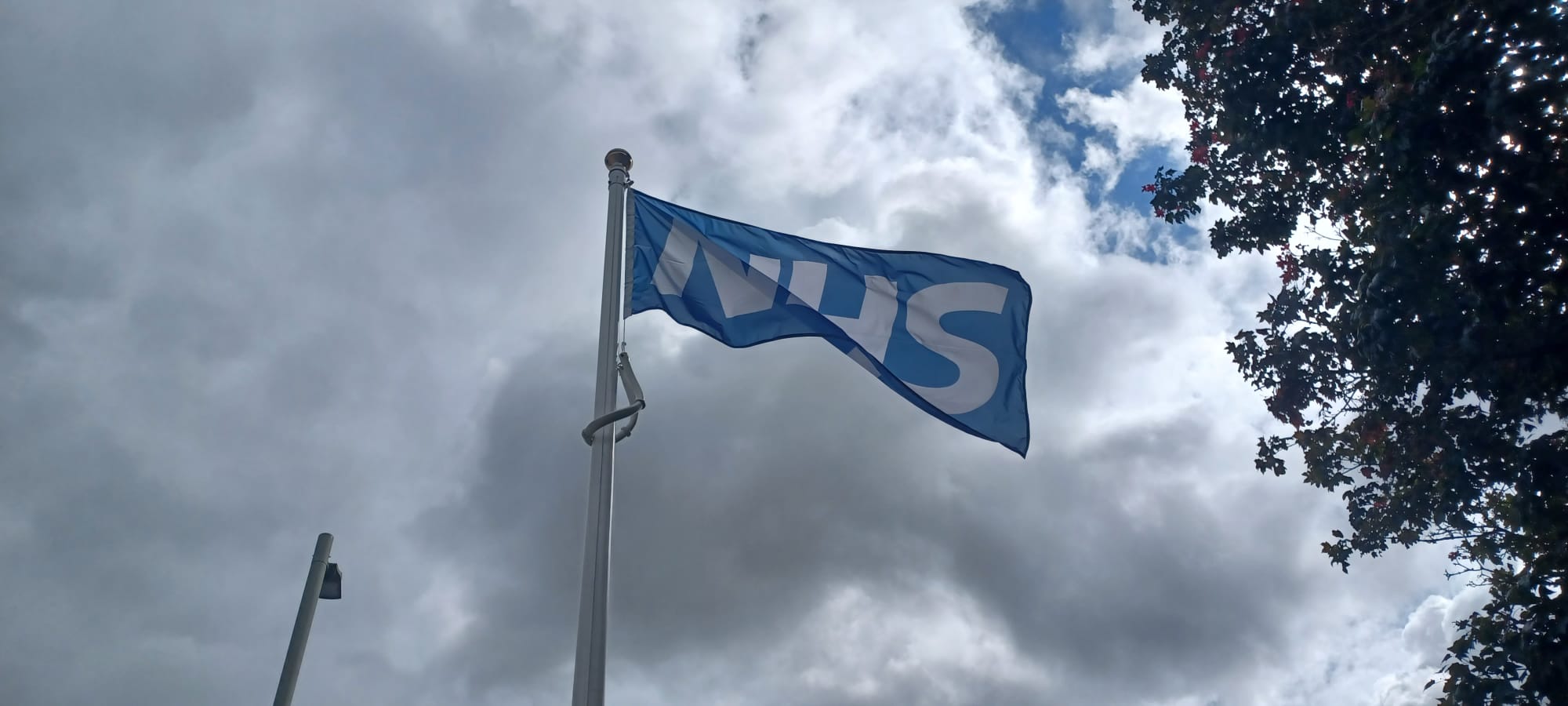 The NHS flag flying from the flagpole