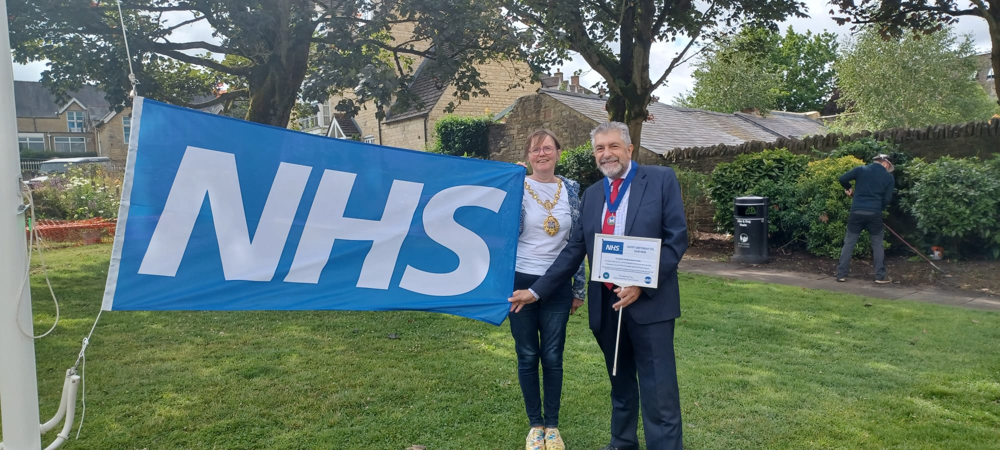 Cllrs Coleman and Akers holding the NHS flag