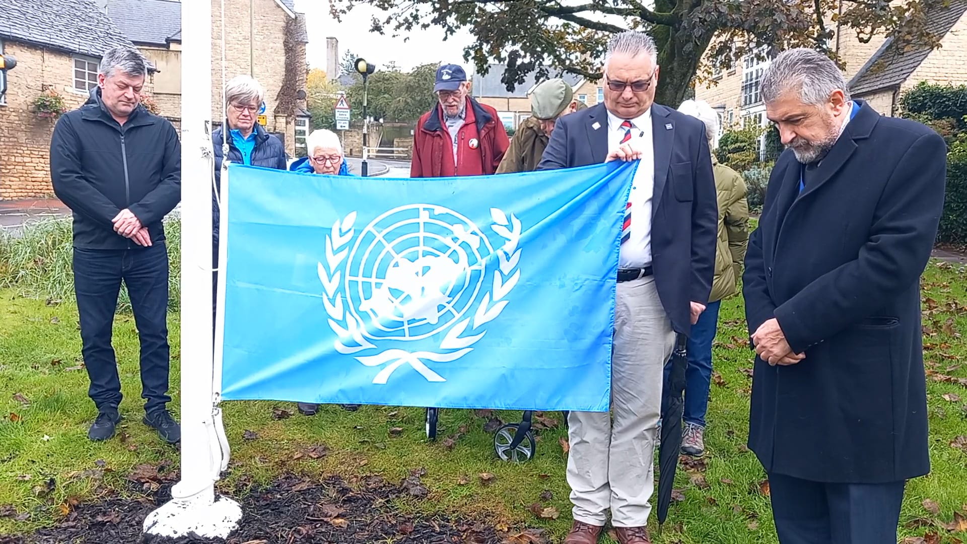 Members of Chipping Norton Amnesty and Chipping Norton Town Council holding a minutes silence 